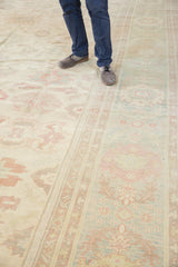 Abrash from ivory to seafoam green showcasing oversized floral patterns on the Sultanabad rug.