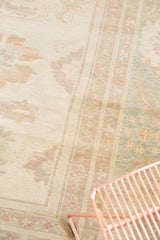 Sultanabad design carpet section with pastel ivory, seafoam green, and terracotta floral vinery.