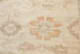 Hand-knotted Sultanabad design pile with large pastel ivory, terracotta, blue, and gray florals.