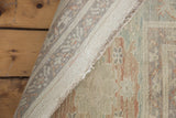 Hand-knotted foundation, serged edge, and pastel patterned pile of the Sultanabad rug.