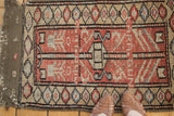 Vintage Turkish Oushak rug frayed corner, woven taupe edge and antique ivory diamond border.