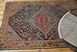 Storied texture and brick red border detail of a vintage distressed Mahal rug.