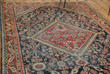 Distressed Mahal rug's brick red medallion, indigo field with celadon henna motifs.