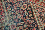 Distressed Mahal rug detail showing serrated step designs, indigo, brick red, and blush tones.