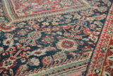 Distressed vintage Mahal rug detail showing intricate patterns in brick red, indigo, and blush.