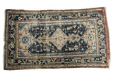 Distressed vintage Malayer rug with beige medallion on a navy geometric field, 3'11