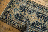 Distressed navy, beige Malayer rug with geometric vinery, stylized bird motifs.