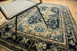 Distressed Malayer rug displaying rectilinear vinery in navy blue, sky blue, and beige.