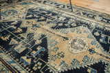 Distressed vintage Malayer rug detail, geometric vinery in beige, navy, and sky blue.