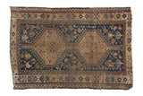 Vintage distressed Qashqai rug, indigo field, copper double medallions, floral and animal motifs.