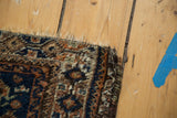 Secure side of distressed Qashqai rug showing aged pile texture, indigo and brown hues.