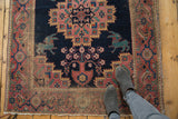 Antique Afshar rug: mythological 'bunny' creatures, vase motif, madder red, and indigo field.