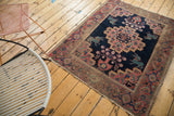 Mythological teal bunny figure and stepped medallion on a distressed antique Afshar rug.