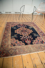 Antique Afshar rug's distressed fringe and geometric border in muted madder red and blush.