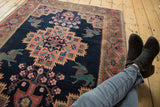 Distressed Afshar antique rug with stepped medallion, mythological creatures, and rich indigo field.