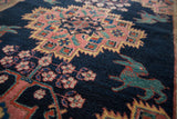 Teal mythological creature with madder red outlines on indigo field of antique Afshar rug.