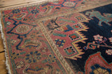 Distressed Afshar rug detail with geometric patterns, a teal creature, and rich gem-tone colors.