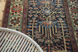 Vintage Baktiari rug features soft long-stemmed floral pattern in muted indigo, madder, bronze.