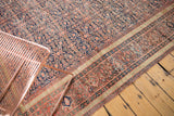 Antique Farahan runner's blush red henna plant motif field and patterned dusty gold borders.