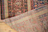 Visible hand-knotted foundation and softly worn blush red, navy patterns of the antique Farahan runner.