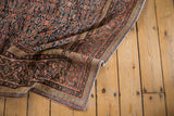 Aged blush brick red and navy details of the antique Farahan rug's henna motif and border.