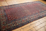 Antique Malayer rug: vibrant red, navy, ivory samovar border with meandering vine details.