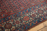 Antique Malayer rug detail: samovar border, blue vines, and red boteh pattern.