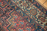Antique Malayer rug detail: samovar style border, navy and red field motifs.
