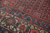 Antique Malayer runner border showcasing bright red samovar and navy blue vine motifs.