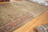 Antique Mahal runner's secured side edge, with moss green field and dark copper patterned border.