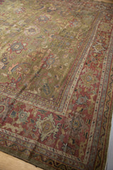 Antique Mahal rug corner detail: moss green field, oversized palmettes, copper burgundy border.