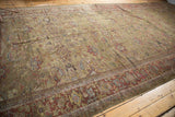 Antique Persian Mahal runner features allover floral palmettes on an unusual dark moss green ground.