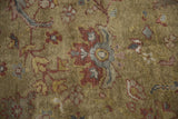 Antique Mahal rug close-up: moss green ground with burgundy, blue, and gold floral palmettes.