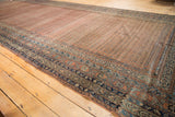 Navy and sky blue borders frame dusty brick red Mir boteh on antique Malayer runner.