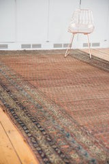 Antique Malayer rug border with navy and sky blue motifs, complementing the dusty red Mir boteh field.