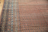 Close-up of Malayer antique runner's dusty brick red Mir boteh field and patterned border.