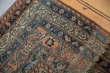 Antique Malayer rug detail: Mir boteh motif in brick red, navy blue, and ivory hues.