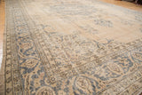 Distressed vintage Sivas carpet texture with faded sand beige, dusty teal, and brown motifs.