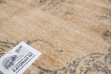 Pale peach and charcoal distressed Sivas carpet with visible knot heads and foundation.