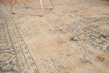 Distressed Sivas carpet surface with faded teal motifs on soft beige pile.