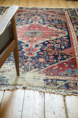 Antique Distressed Josan Sarouk rug corner with exposed foundation and tattered fringe.