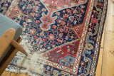 Hard wear exposing foundation and tattered fringe on an antique Josan Sarouk rug corner.