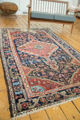 Antique Distressed Josan Sarouk rug end with navy blue geometric vinery and tattered fringe.