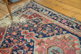 Distressed Josan Sarouk rug end with exposed foundation, tattered fringe, and geometric pattern.