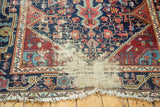 Textural detail of antique Josan Sarouk rug, showing exposed foundation and worn fringe.
