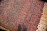 Vintage Moroccan Jijim carpet, geometric banded patterns in dusty rose and charcoal.