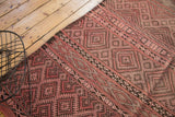 Vintage Moroccan Jijim flatweave with geometric banded motifs in dusty rose and charcoal.