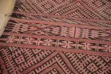 Hand-woven texture of vintage Jijim carpet, dusty rose and charcoal banded geometric patterns.