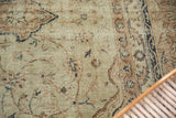 Distressed pile of the vintage Sparta carpet with faded ivory, beige, and navy floral motifs.