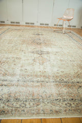 Vintage distressed Sparta carpet with faded beige and dark floral motifs, showing worn texture.